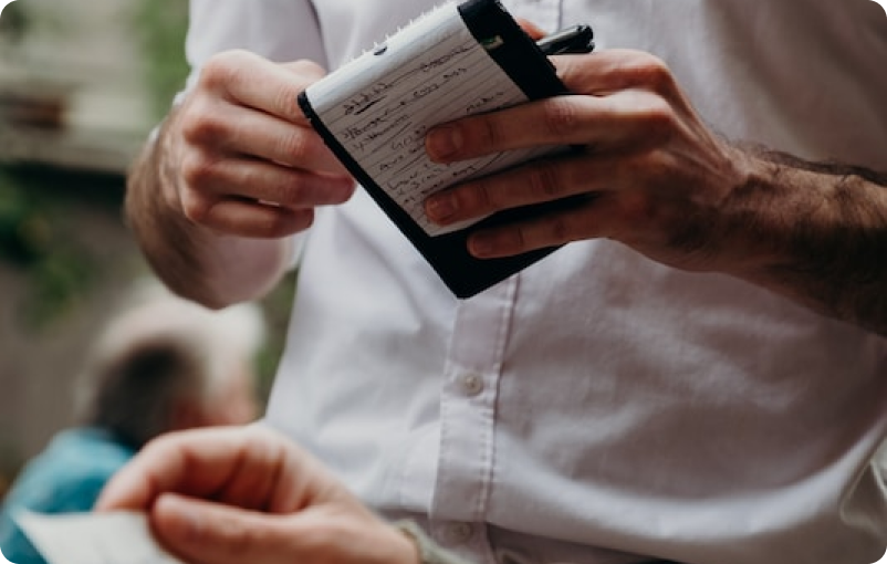 waiter taking an order on a black notepad